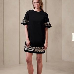 Navy dress with sleeve and hem embroidered detail